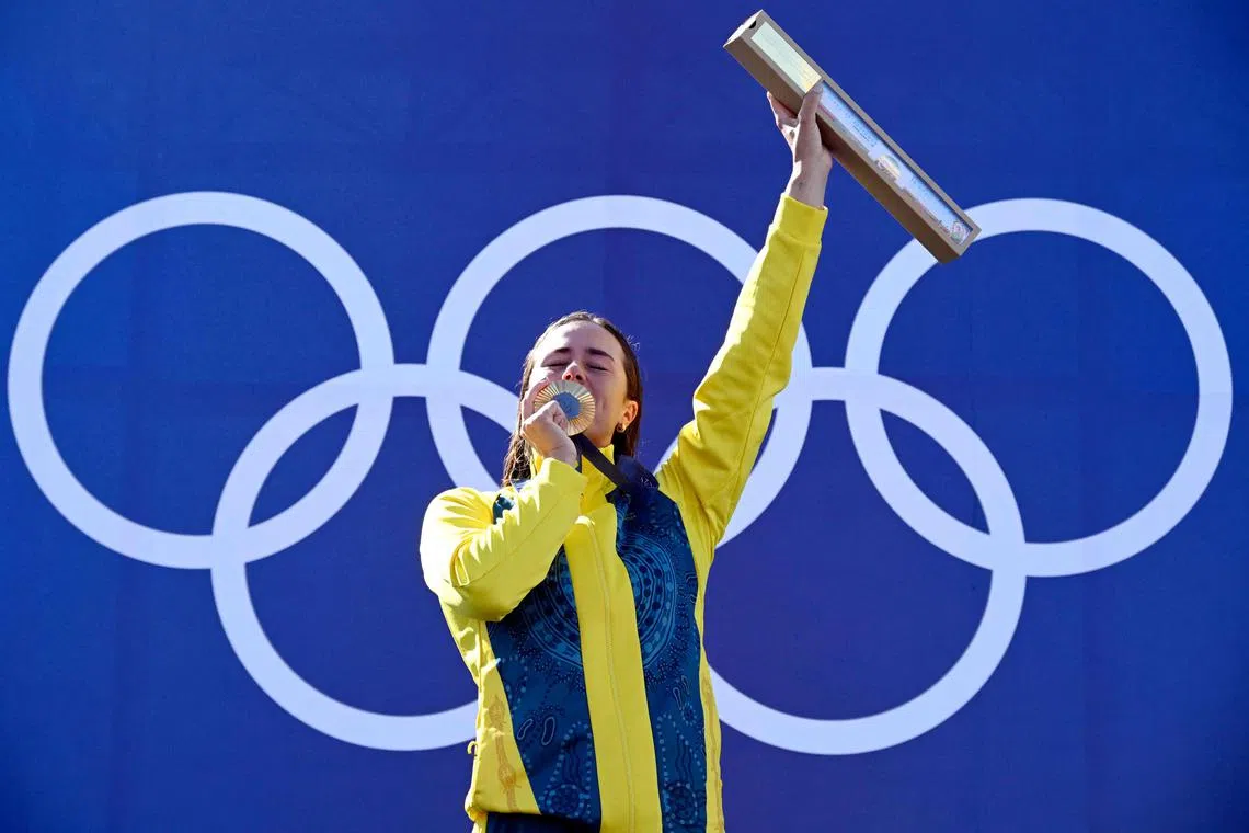 Australia's gold medallist Noemie Fox celebrates on the podium during the medal ceremony after the women's kayak cross final.