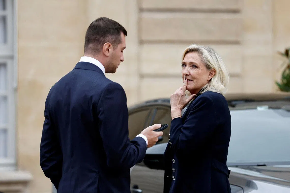FILE PHOTO: Jordan Bardella, president of the French far-right National Rally (Rassemblement National - RN) political party, and French far-right leader and member of parliament Marine Le Pen leave after a meeting with the French Prime Minister as part of a series of consultations with political parties, a week before a confidence vote he is seeking from the National Assembly on the budget issue, at the Hotel Matignon in Paris, France, September 2, 2025. REUTERS/Benoit Tessier/File Photo