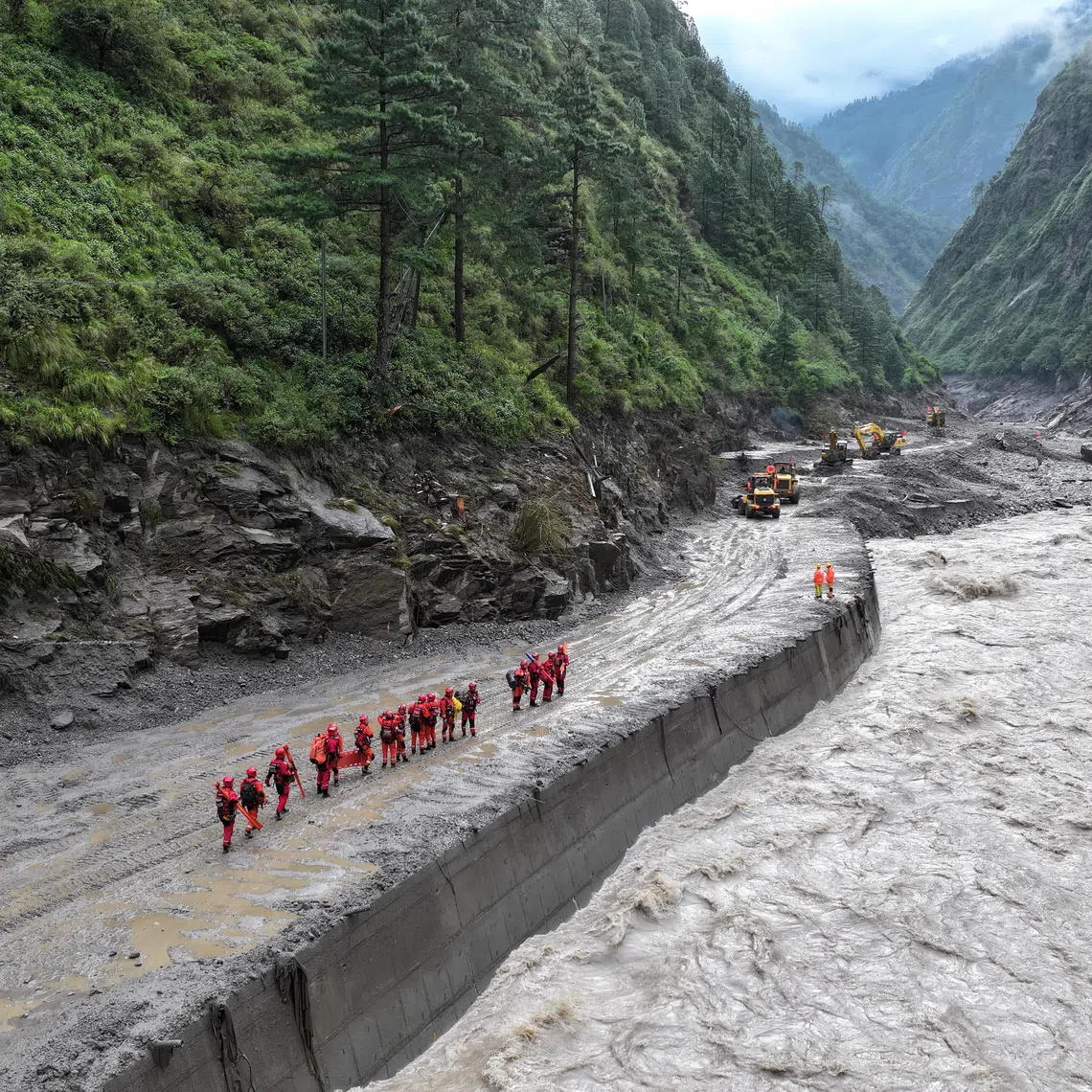A drone view of firefighters conducting search and rescue operations at a damaged road leading to Gyirong Port after a mudslide, in Gyirong county, Shigatse, Tibet Autonomous Region, China August 28, 2026. cnsphoto via REUTERS