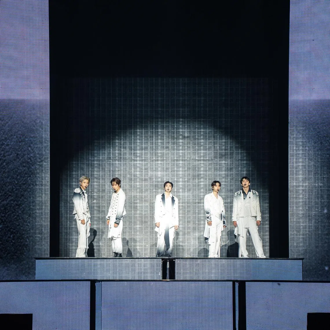 Exo performing the song Crown (2026) during their concert at the Singapore Indoor Stadium on July 24. The five active members are (from left) Chanyeol, Kai, Suho, D.O. and Sehun.