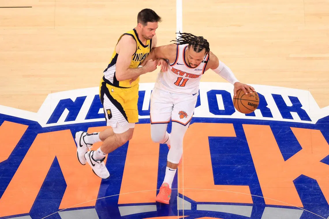 NY Knicks' point guard Jalen Brunson dribbles the ball under pressure from the Indiana Pacers' point guard TJ McConnell during Game 5.