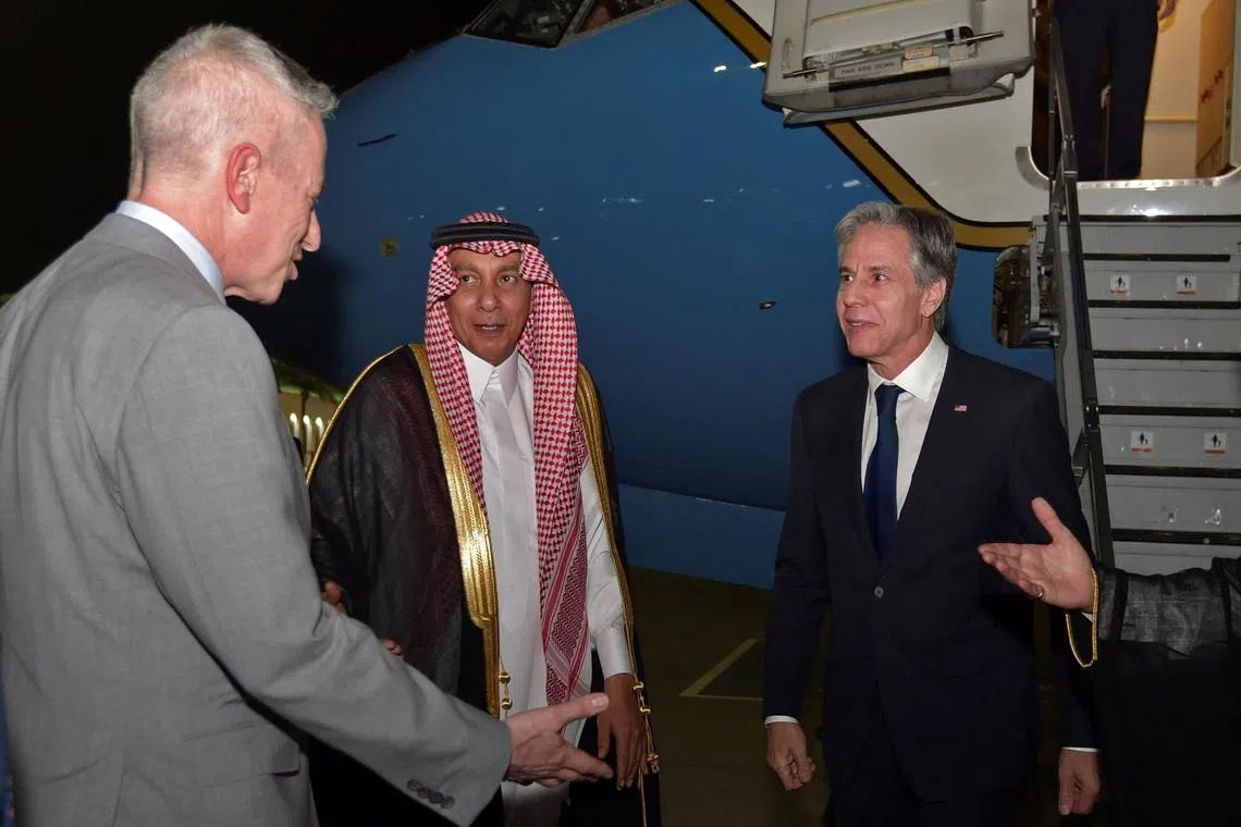 US Secretary of State Antony Blinken is welcomed by US ambassador to Saudi Arabia Michael Ratney and a Saudi official upon his arrival in Jeddah.