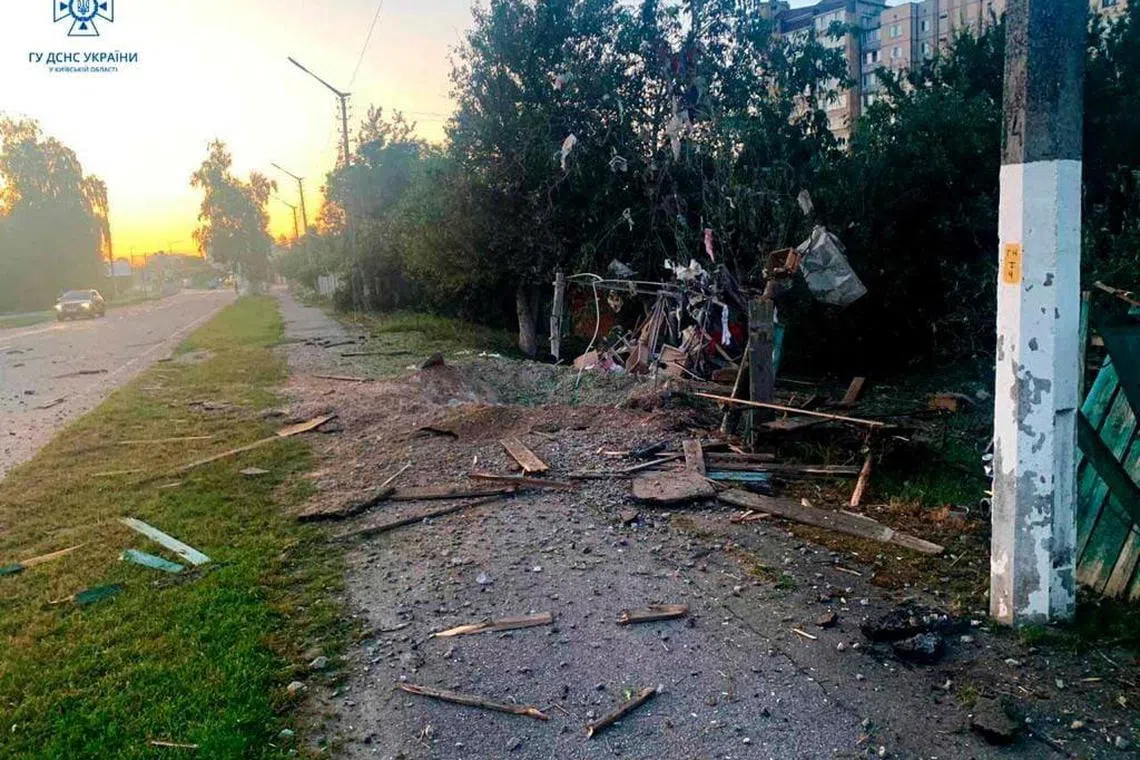 A crater left by remains of a shot-down suicide drone is seen following Russia's attack on Ukraine, in the Kyiv region on Tuesday. 