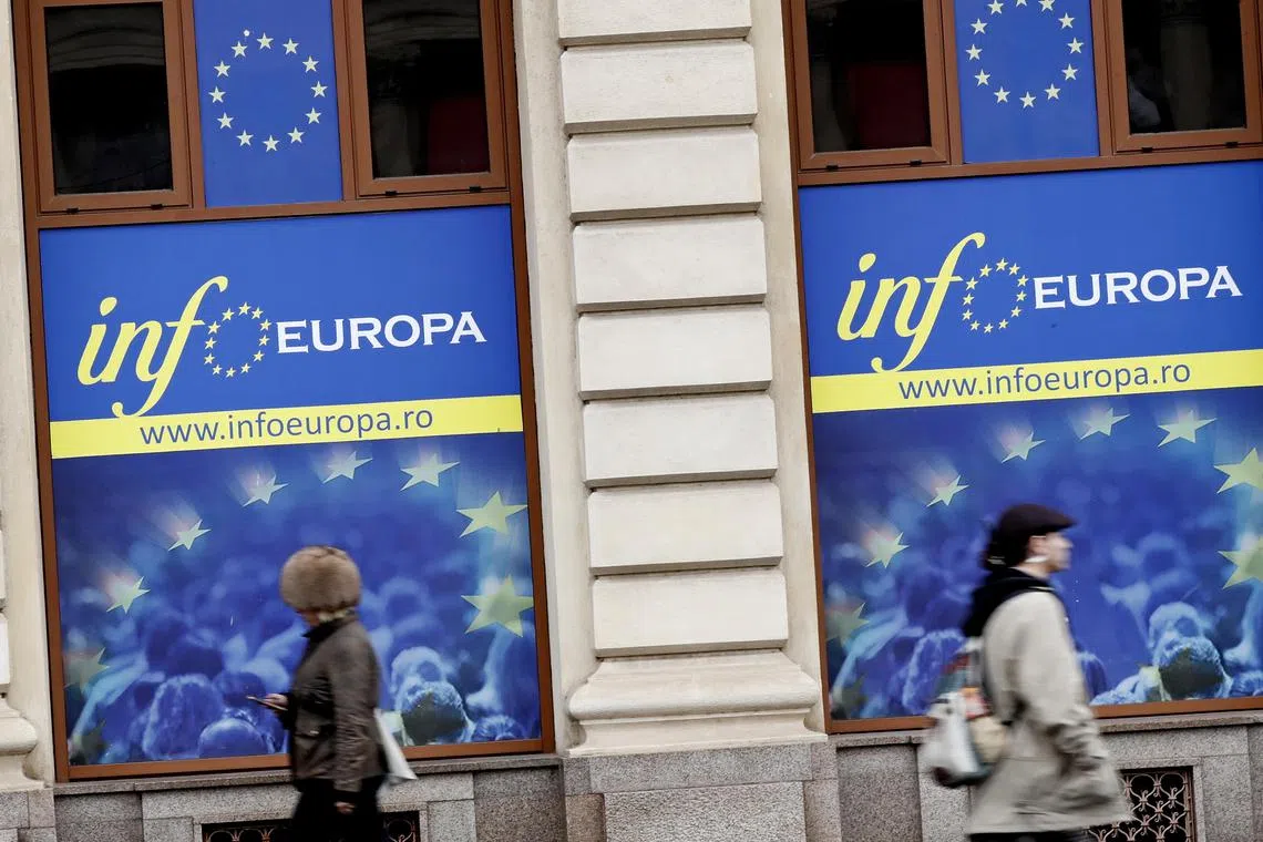 epa10355167 People pass by EU labeled posters mounted on the windows of the European Council Info Center, in downtown Bucharest, Romania, 08 December 2022. Ministers from the 27 EU member states have been voting on expanding the Schengen visa-free zone to include members Bulgaria, Romania and Croatia, but only Croatia will join the Schengen area from the beginning of 2023, after receiving a positive vote at the EU Home Affairs Interior ministers Council held in in Brussels on 08 December 2022. Austria used its veto for the Romania and Bulgaria candidate countries, on concerns over the organized crime, unauthorized migration and security.  EPA-EFE/Robert Ghement