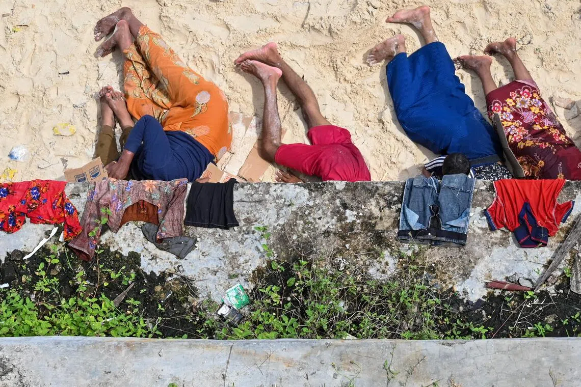 Newly-arrived Rohingya refugees resting on a beach in Sabang island, Aceh province on Nov 22, 2023.