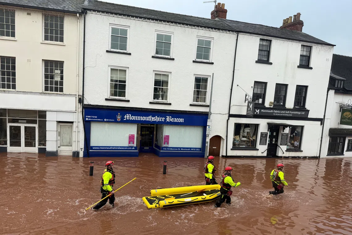 Rescue workers wade through floodwater after severe flooding in south Wales, as Storm Claudia reaches parts of the United Kingdom, in Monmouth, Wales, Britain, November 15, 2025 in this picture obtained from social media. Kim Kaos/via REUTERS