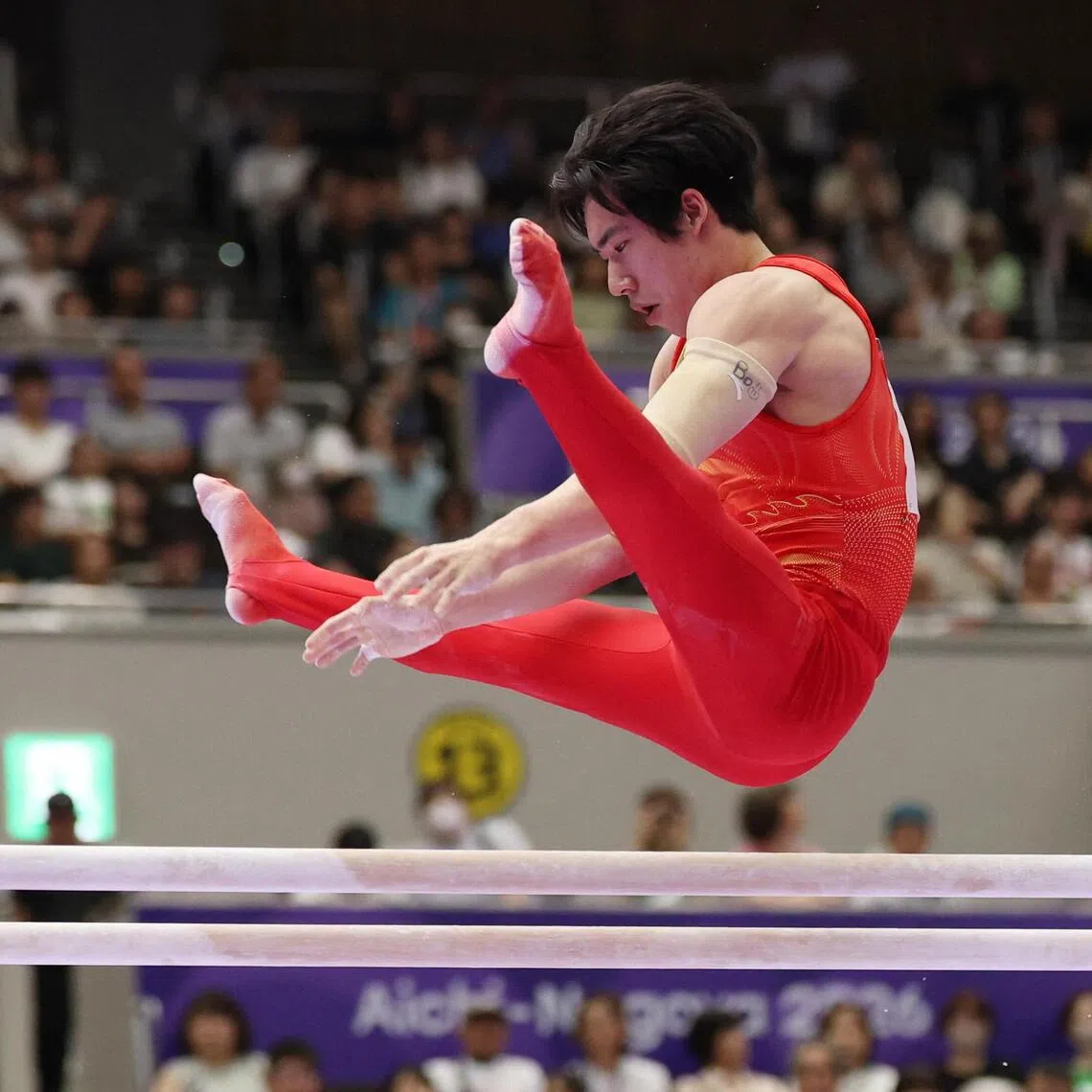 China’s Zhang Boheng performing his routine on the parallel bars en route to winning the men’s all-around gymnastics gold at the Asian Games in Japan on Sept 21.