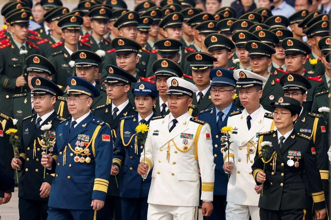 Members of China's military attend a wreath laying ceremony on Tiananmen Square to mark Martyrs' Day on the eve of the National Day in Beijing, China September 30, 2022. REUTERS/Thomas Peter