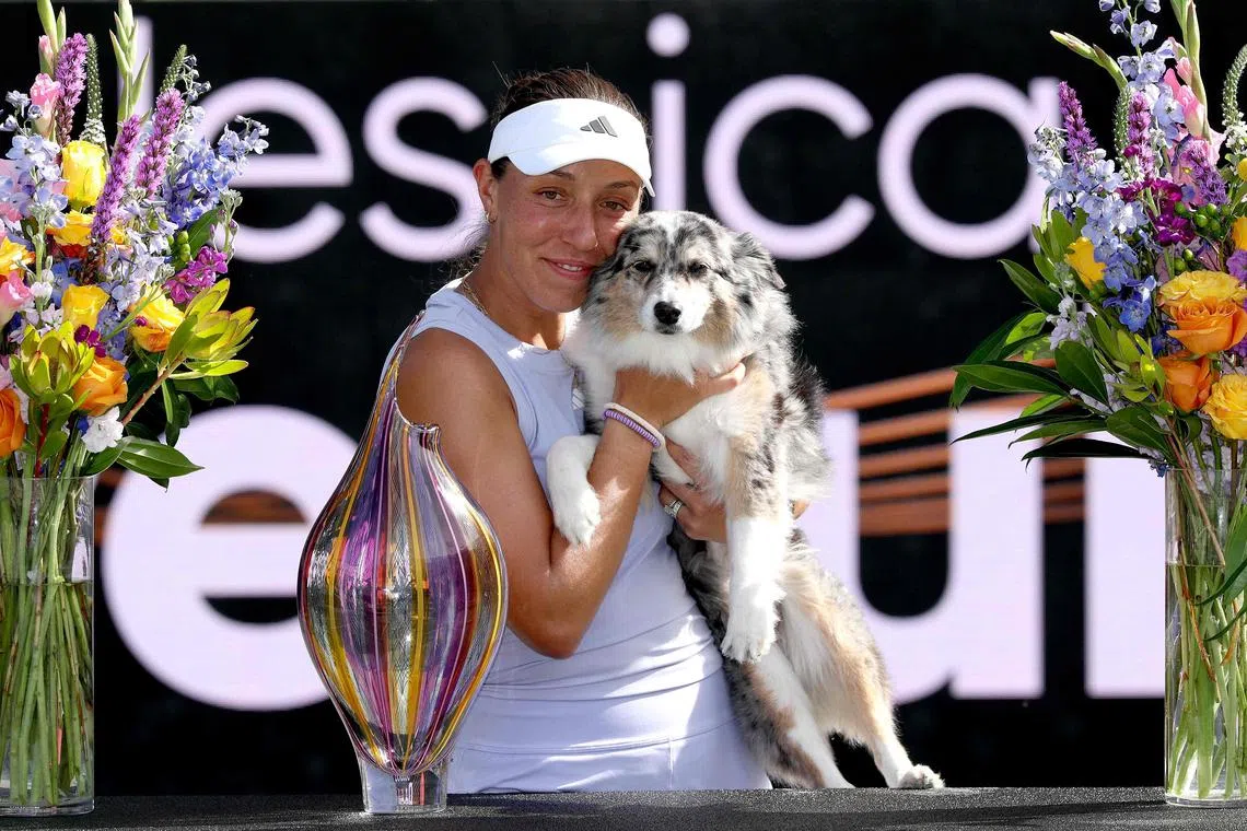 Jessica Pegula with the trophy and her dog Maddie after defeating fellow American Sofia Kenin in the Charleston Open final at Credit One Stadium on April 6, 2025 in South Carolina.