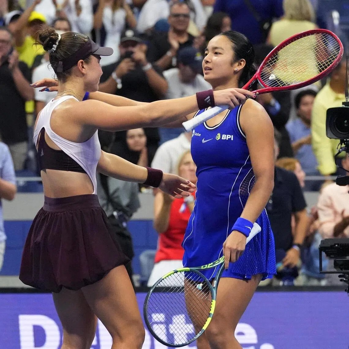 Iva Jovic of the US embraces Philippines’ Alexandra Eala after winning their US Open third-round match.