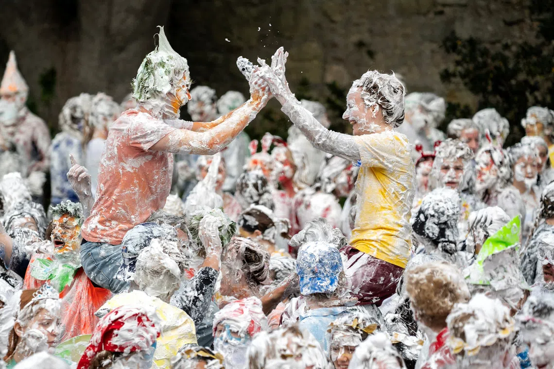Students from St Andrews take part in a foam fight, as part of "Raisin Monday" in the Lower College Lawn, at St Andrews in Scotland, Britain, October 19, 2026. REUTERS/Lesley Martin