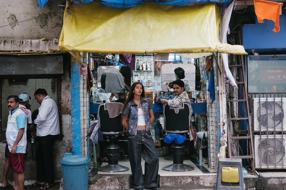 Diya Joukani in front of the barbershop near the workshop for her brand, DiyaDiya in the Bandra neighborhood of Mumbai, India, on July 7. Joukani’s popular videos on social media documenting her daily life in Mumbai have earned her a reputation as “the cool girl from India”. She has parlayed it into her brand.