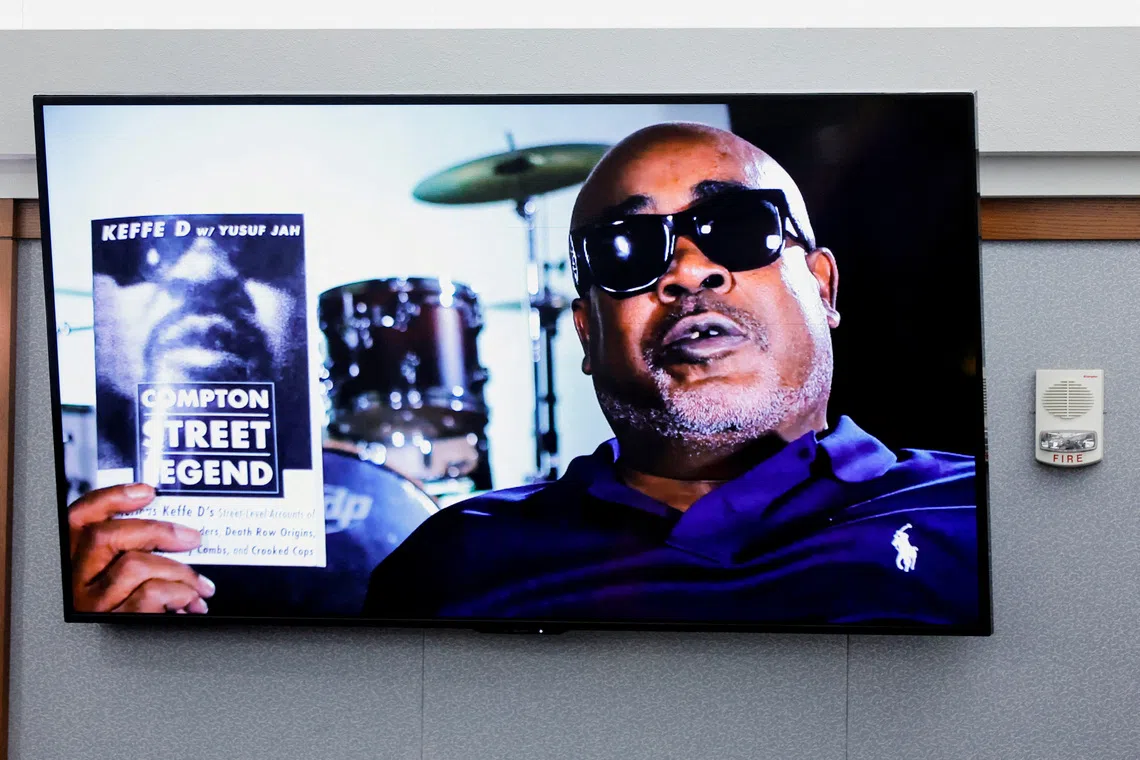 A photo of Duane Davis holding his book "Compton Street Legend" is displayed in court during the Duane Davis murder trial, related to the 1996 killing of rapper Tupac Shakur, at Clark County District Court Regional Justice Center in Las Vegas, Nevada, U.S., Monday, August 17, 2026. REUTERS/Steve Marcus/Pool TPX IMAGES OF THE DAY