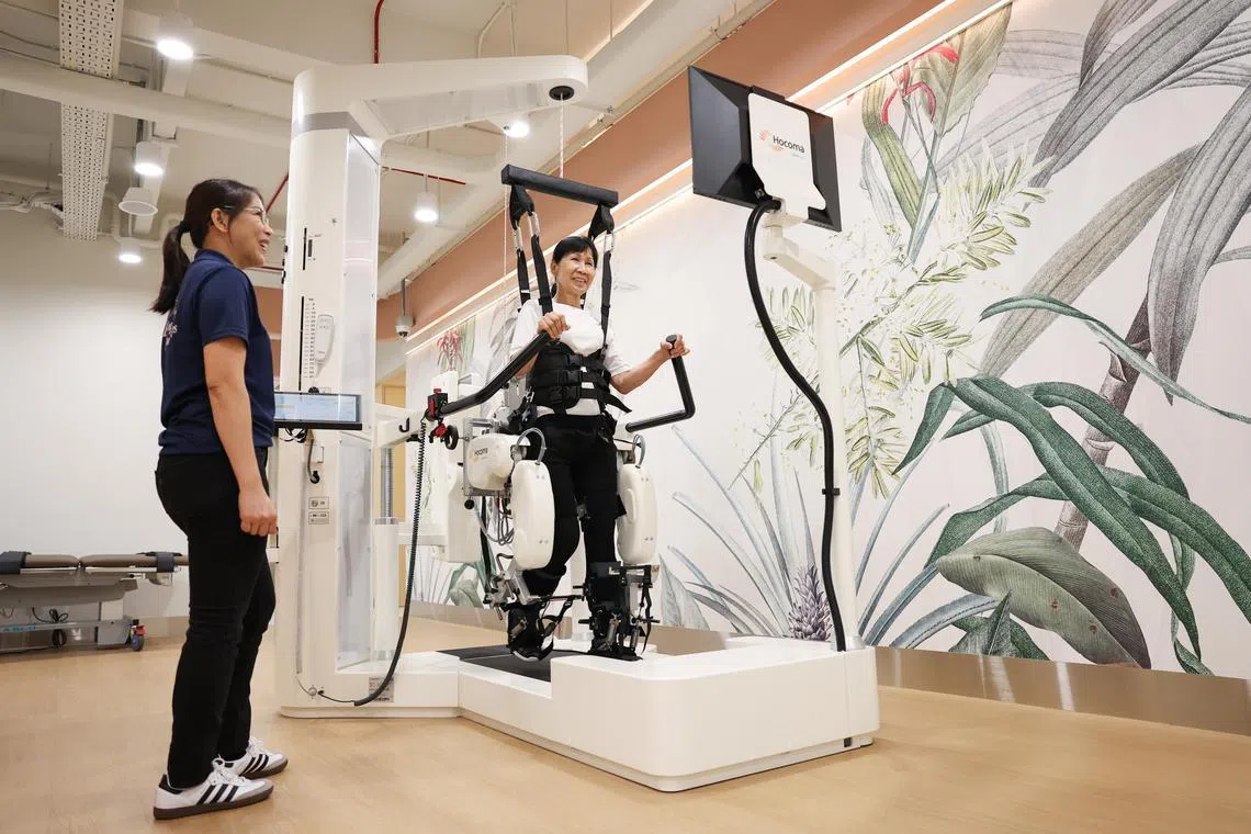 Ms Susan Lee, 70, a Bukit Batok resident, using the Lokomat Nanos machine which helps to strengthen the user's legs.