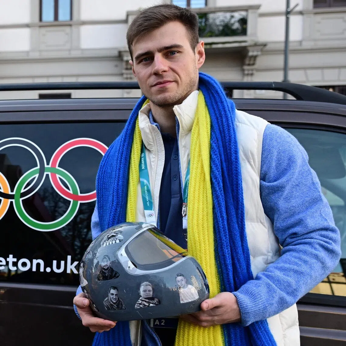 Ukrainian skeleton athlete Vladyslav Heraskevych posing with his banned helmet after a hearing at the Court of Arbitration for Sport in Milan on Feb 13.