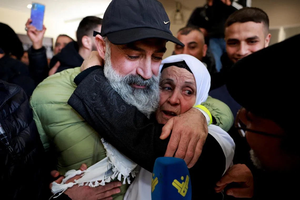 A freed Palestinian prisoner is embraced after being released from an Israeli jail as part of a hostages-prisoners swap and a ceasefire deal in Gaza between Hamas and Israel, in Ramallah, in the Israeli-occupied West Bank on Feb 15.