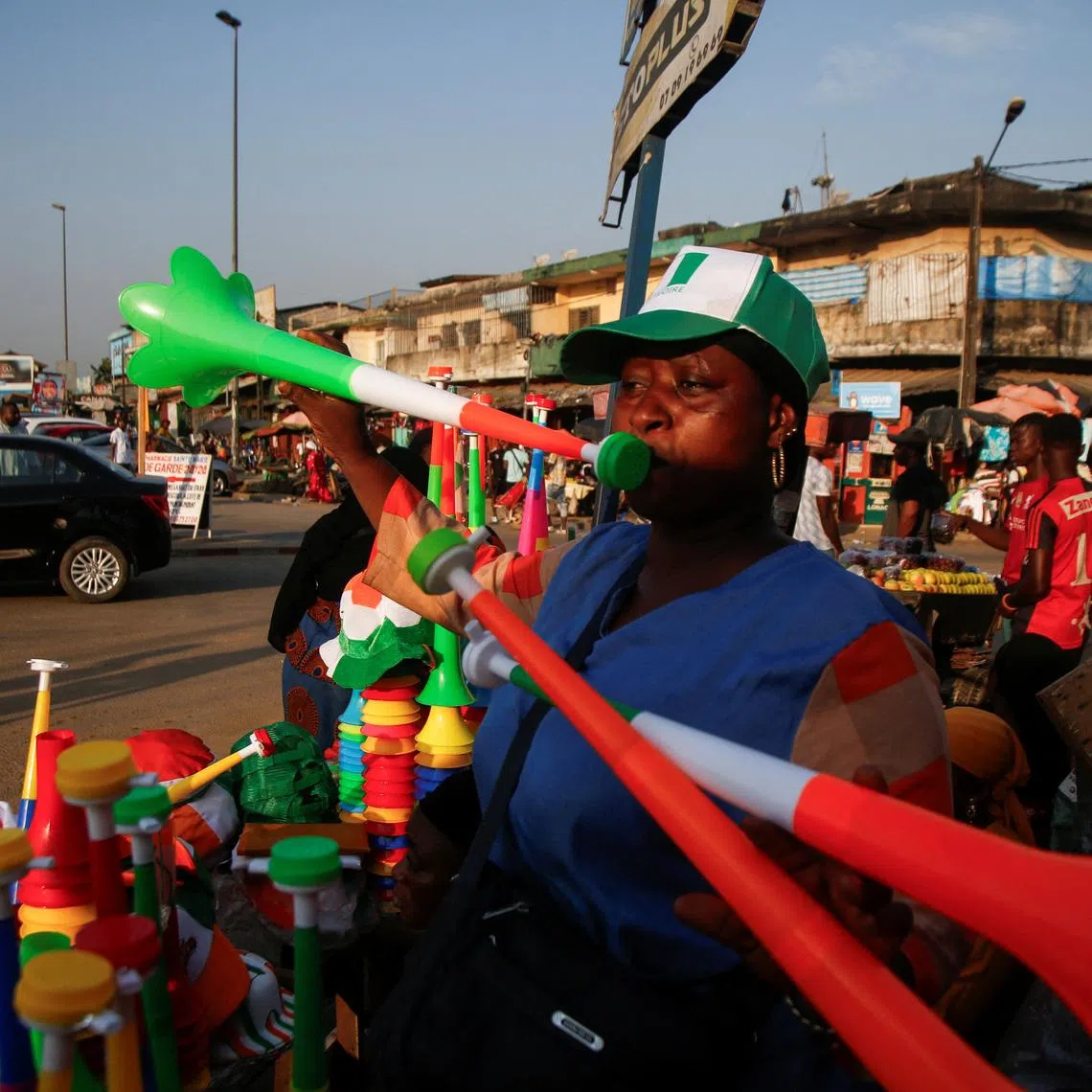 FILE PHOTO: A vendors plays Vuvuzelas while people in Abidjan are getting excited as Ivory Coast gears up to host the Africa Cup of Nations which begins on Saturday in Abidjan, Ivory Coast January 10, 2024. REUTERS/Luc Gnago/ File Photo