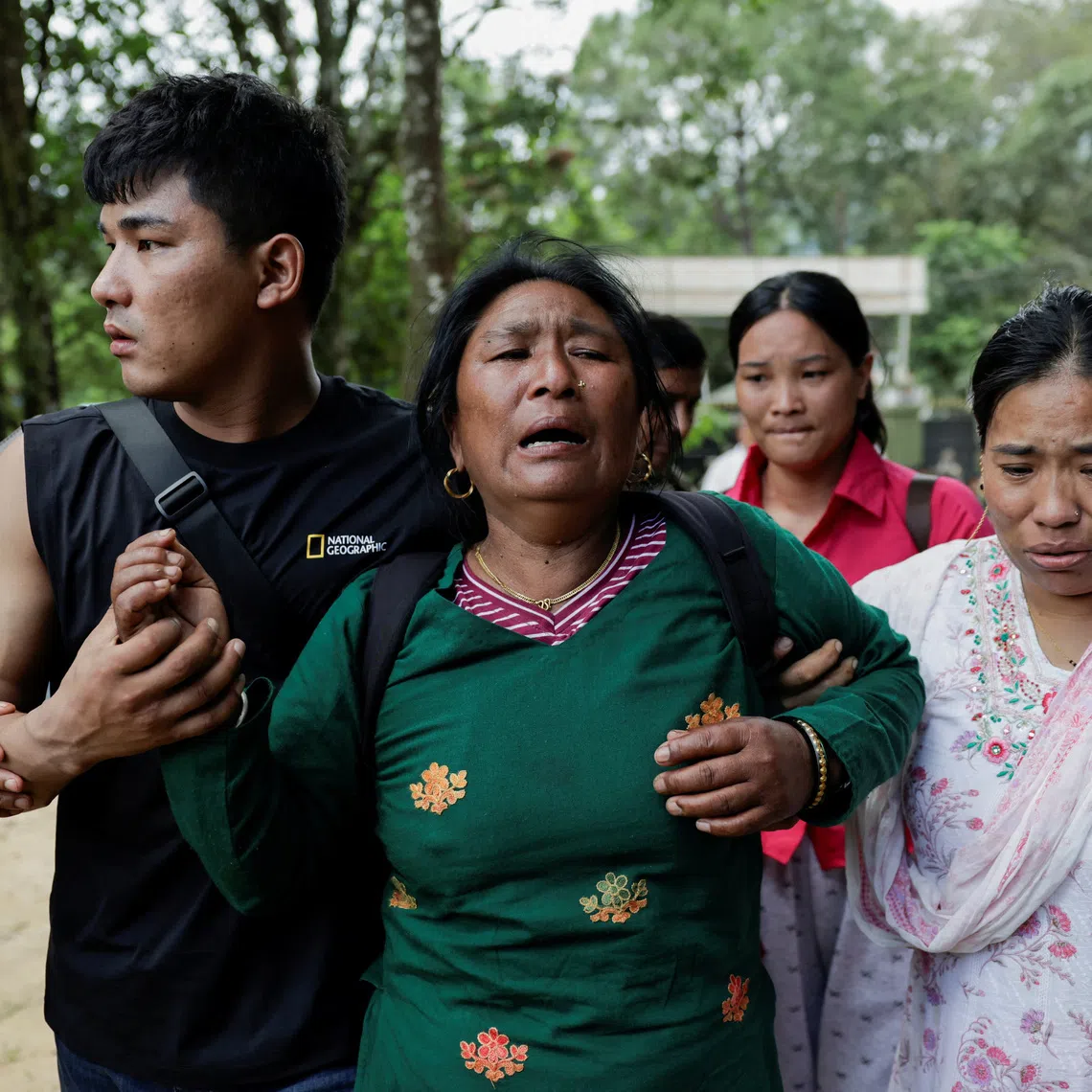 A woman affected by flash floods and mudslide, arrives at the Maithali Barrack, an army training center, at Trishuli in Nuwakot district, Nepal, August 28, 2026. REUTERS/Navesh Chitrakar