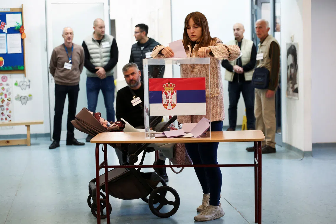 A woman votes at a polling station during the parliamentary election in Belgrade, Serbia, October 25, 2026. REUTERS/Zorana Jevtic