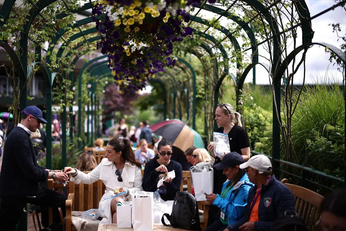 Fans arriving for the Wimbledon Championships at The All England Lawn Tennis and Croquet Club in Wimbledon, south-west London, on July 7, 2024.