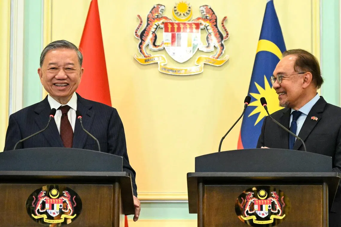 Mr Anwar Ibrahim (right) and Mr Lam (left) attend a press conference in Putrajaya on Nov 21.