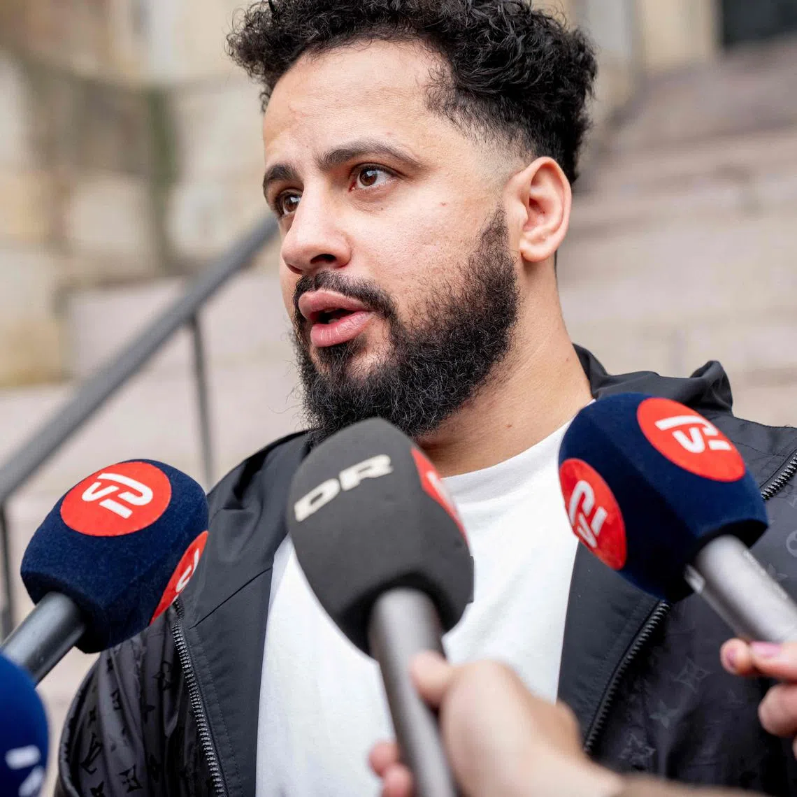 Ahmed Samsam, a Danish citizen of Syrian origin who claims time he spent with the Islamic State (IS) group was as an agent for Danish intelligence, gives a statement in front of the press after the verdict in his case against the intelligence service at Denmark's Supreme Court in Copenhagen on September 2, 2025. Denmark's Supreme Court on September 2 ordered the country's intelligence services to admit that the Danish man of Syrian origin was their informant, which they immediately did. (Photo by Ida Marie Odgaard / Ritzau Scanpix / AFP) / Denmark OUT