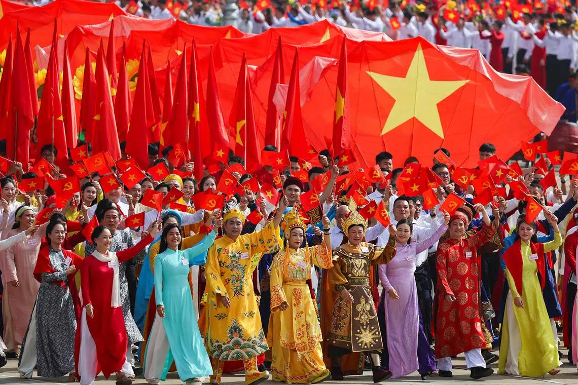 People take part in a parade celebrating the 80th anniversary of independence in Hanoi, Vietnam, Sept 2, 2025. 