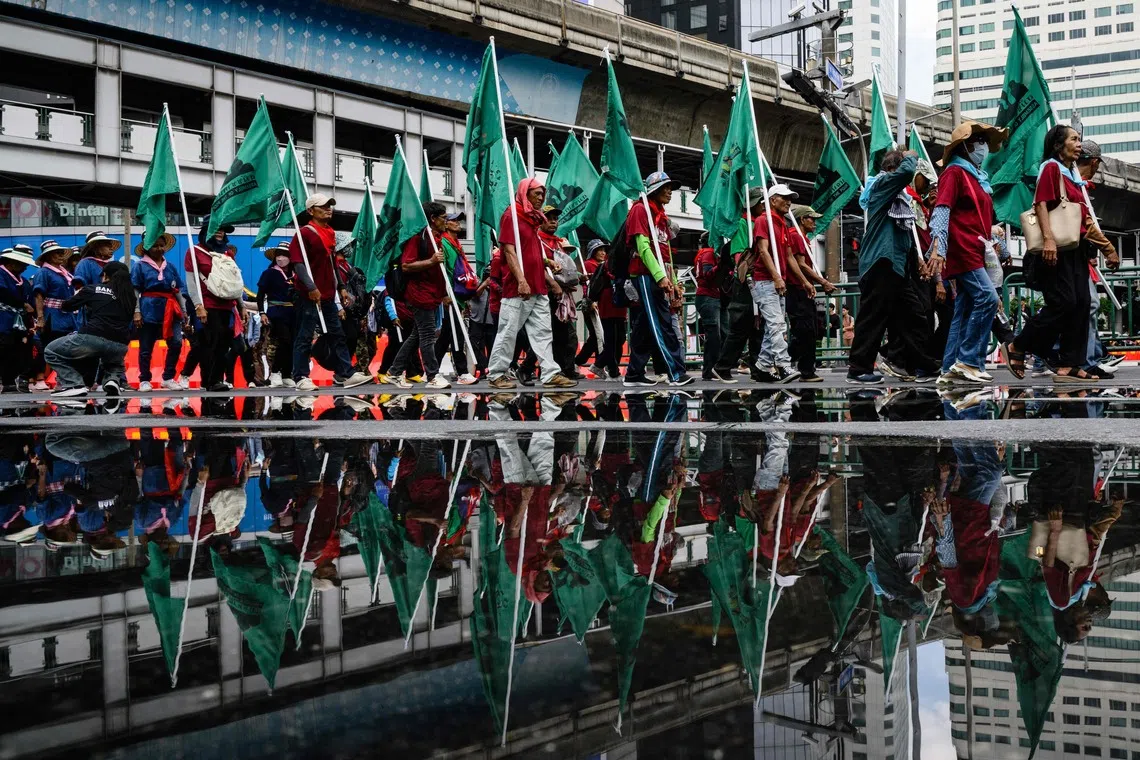 Demonstrators march during a protest against the International Monetary Fund and World Bank Group in Bangkok.