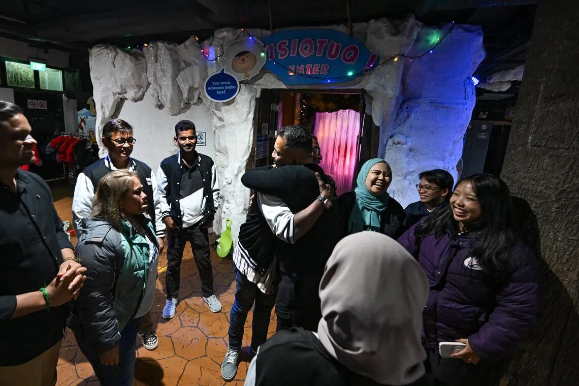 General manager Norazani Shaiddin (centre, in black) hugging a staff member at the end of the day.