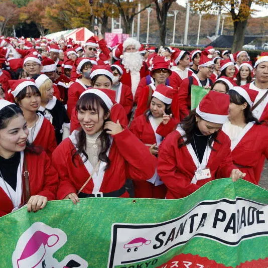 Participants at the 'Santa Parade' charity gift-giving event in Japan. Santa Claus may be traditionally a male figure but the heavy lifting in Christmas giving is done by women, says the writer. 