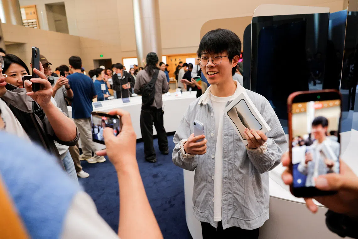 Jiang Jialin, the first customer to purchase the iPhone Duo at Apple’s Jing’an store in Shanghai on Oct 23.