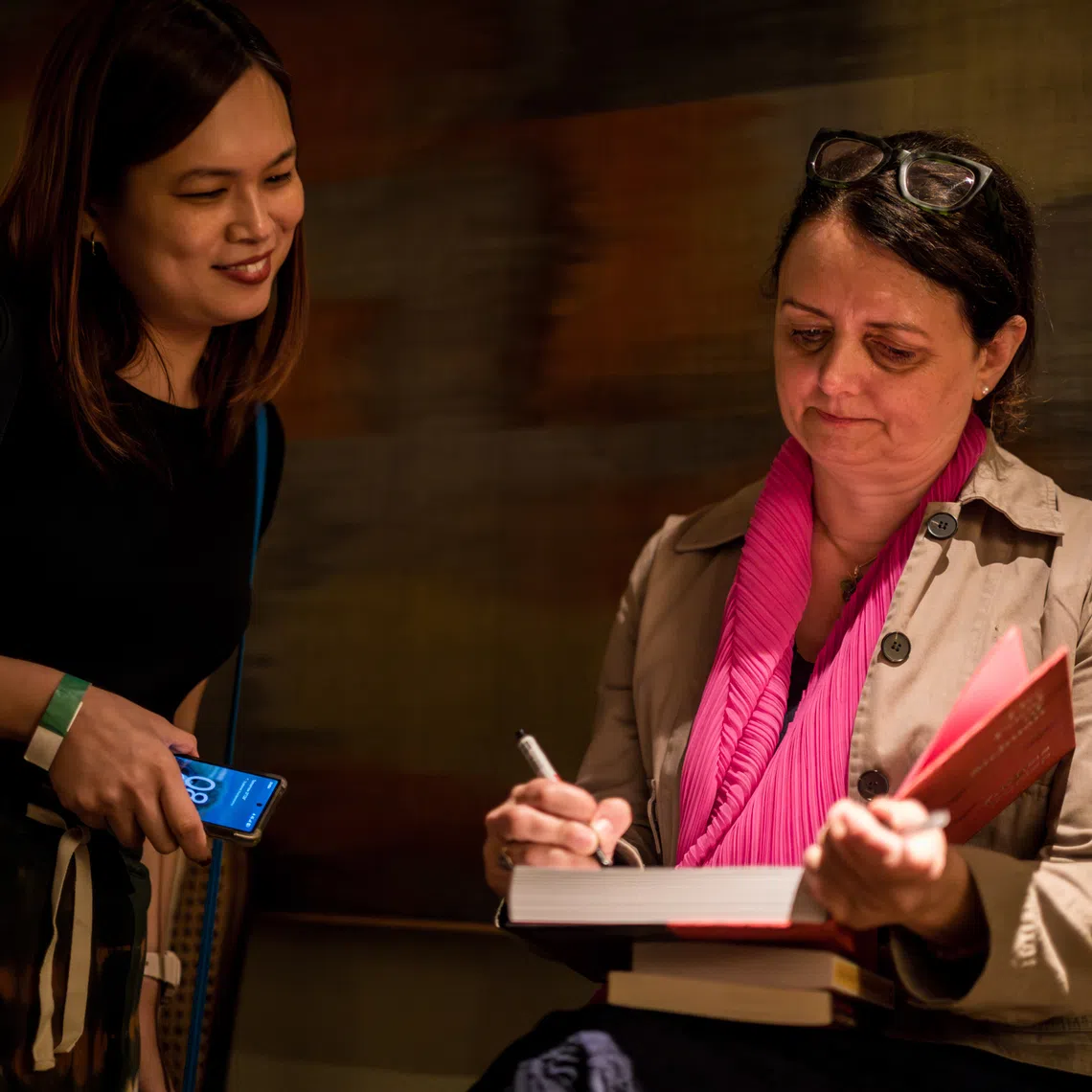 Author Fuchsia Dunlop signing a book for a fan at her Salon session.