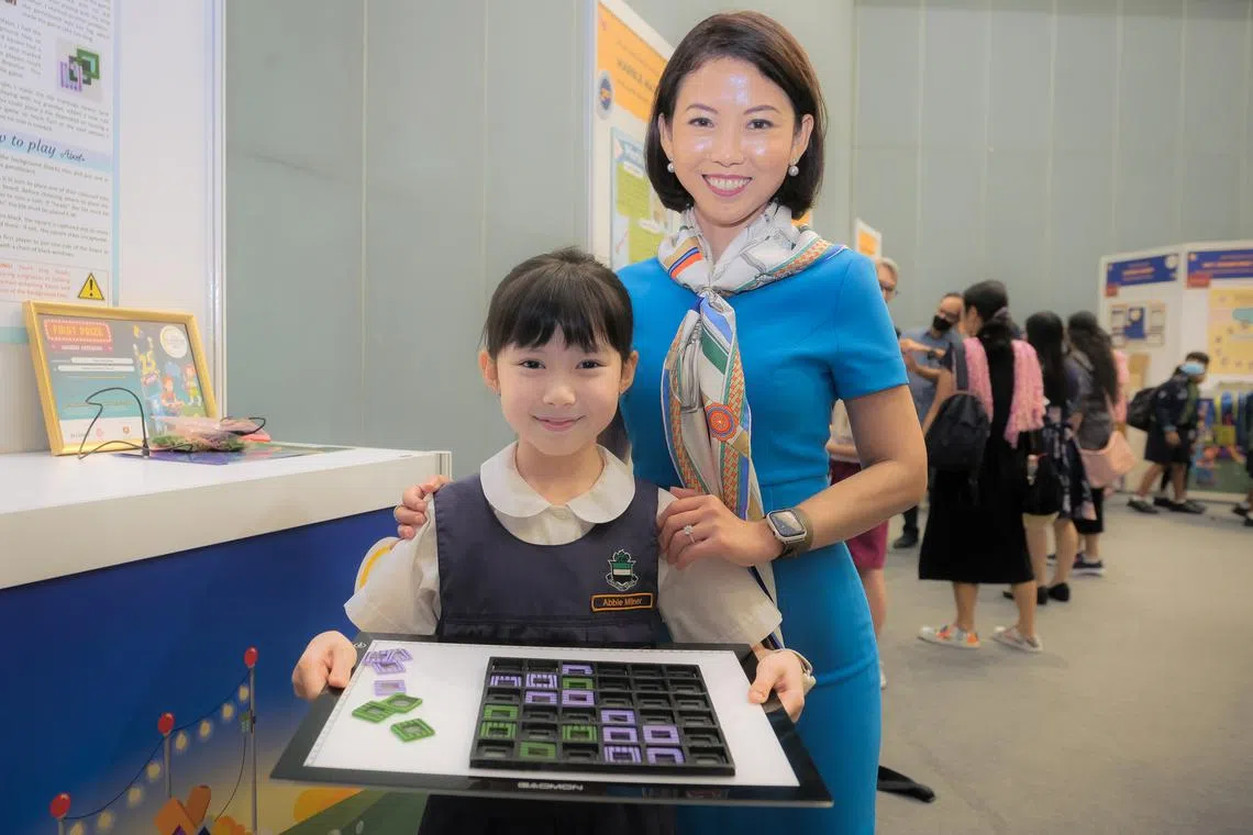 Raffles Girls’ Primary School pupil Abbie Milner with her mother and the 3D board game she created.