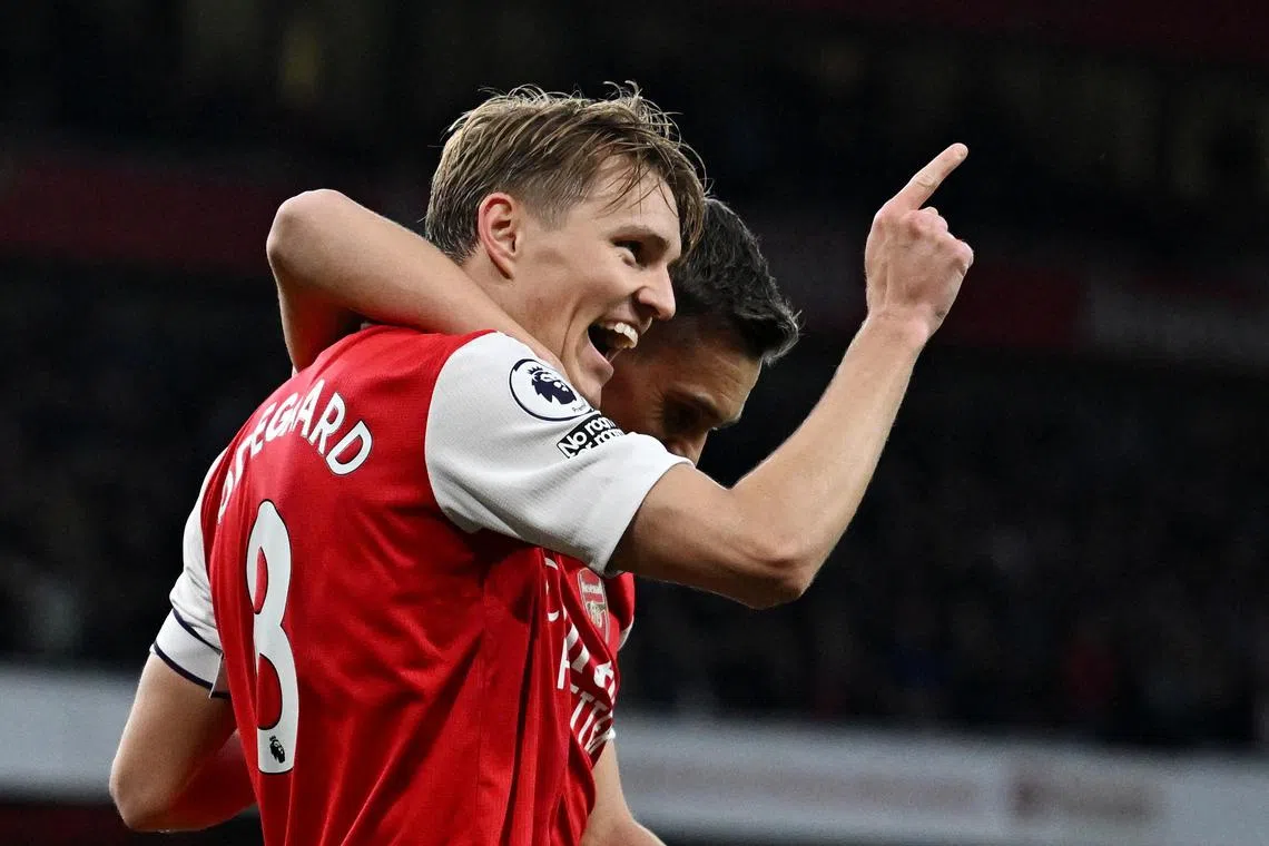 Arsenal's Martin Odegaard celebrates scoring their second goal with Leandro Trossard.
