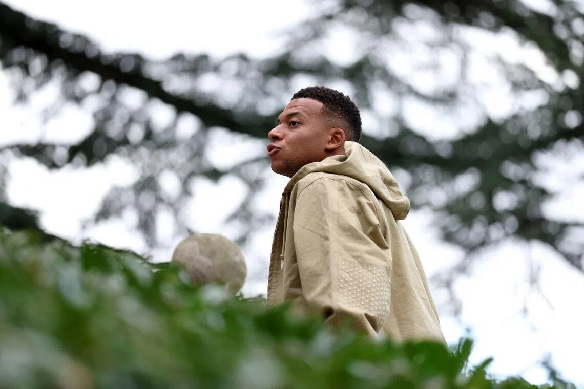 France's Kylian Mbappe arrives for a training session at the team's training grounds in Clairefontaine-en-Yvelines.