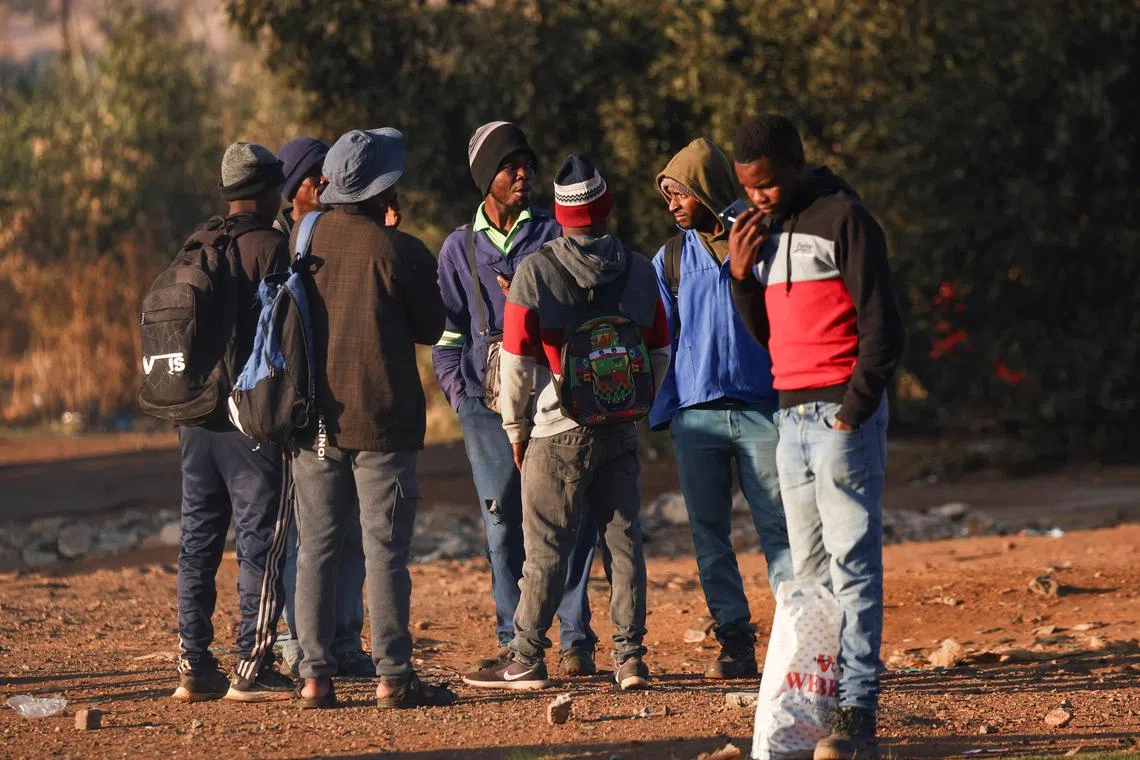 FILE PHOTO: Job seekers wait beside a road for casual work offered by passing motorists, in Eikenhof, south of Johannesburg, South Africa, September 19, 2024. REUTERS/Siphiwe Sibeko/File Photo