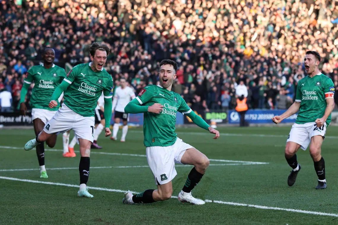 Soccer Football - FA Cup - Fourth Round - Plymouth Argyle v Liverpool - Home Park, Plymouth, Britain - February 9, 2025 Plymouth Argyle's Ryan Hardie celebrates scoring their first goal with Callum Wright and Adam Randell REUTERS/David Klein