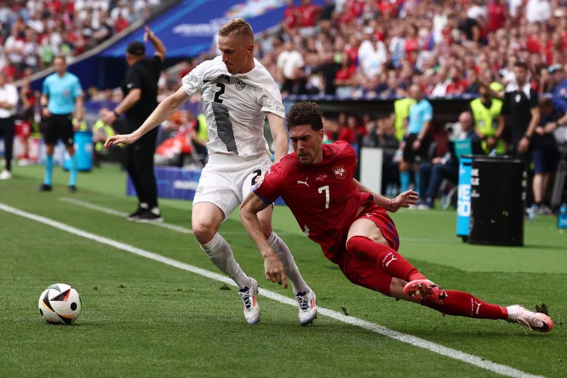 Zan Karnicnik of Slovenia (left) battling for the ball with Dusan Vlahovic of Serbia during their Euro 2024 Group C clash.