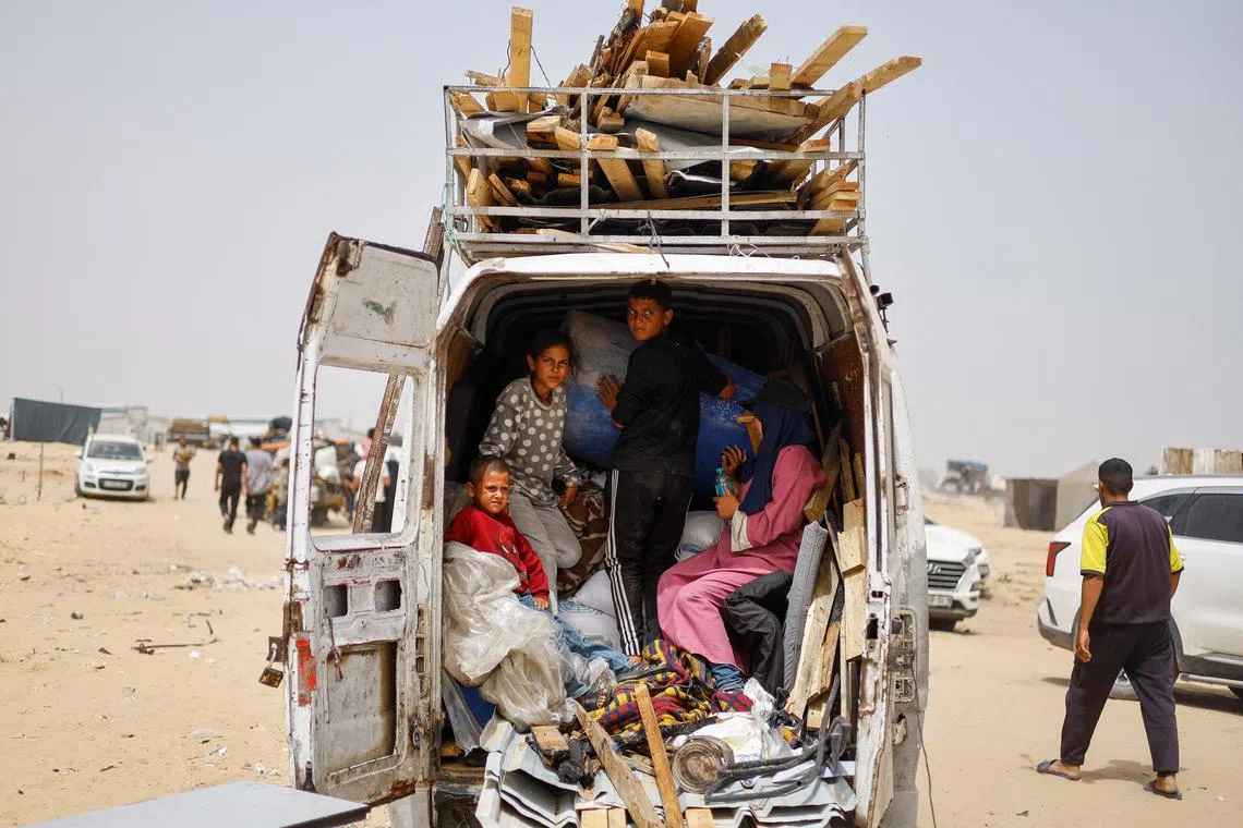 Displaced Palestinians of Salman family ride in a vehicle loaded with their belongings as they prepare to flee Rafah following a nearby Israeli strike on an area designated for displaced, in Rafah in the southern Gaza Strip, May 27, 2024. REUTERS/Mohammed Salem