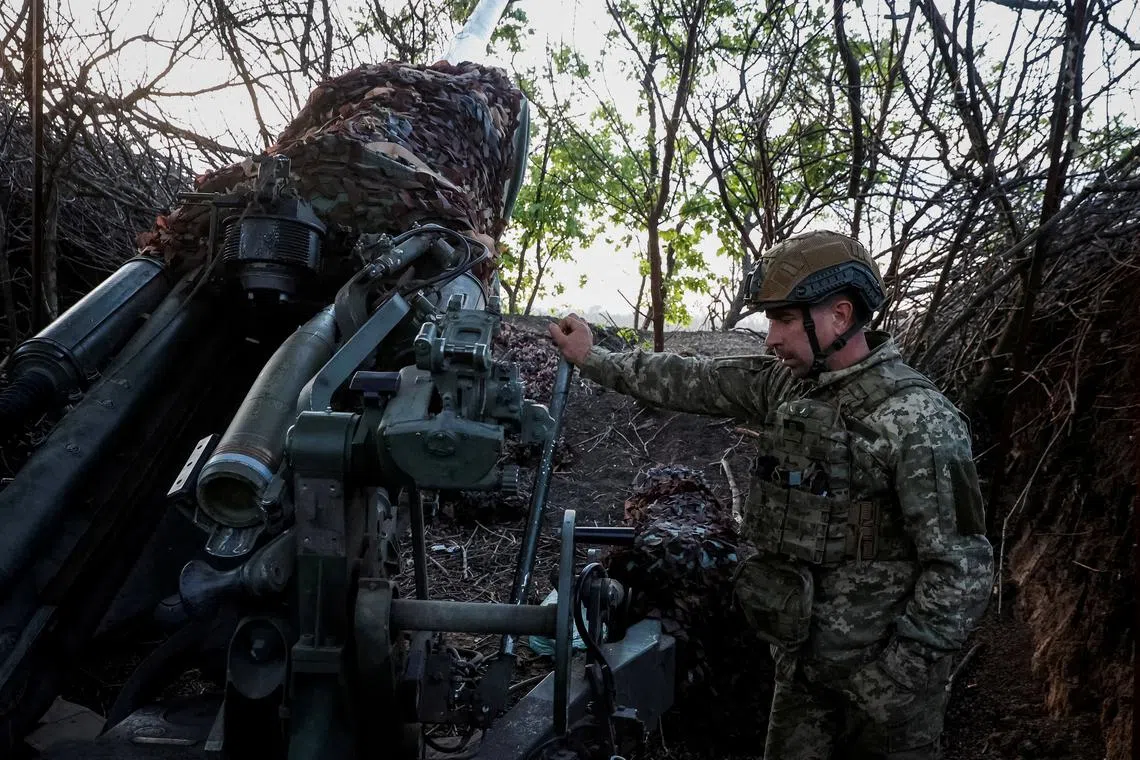FILE PHOTO: A serviceman of the 1148th separate artillery brigade of Air Assault Troops of Ukraine prepares a M777 howitzer to fire towards Russian troops, amid Russia's attack on Ukraine, in Donetsk region, Ukraine April 20, 2024. Radio Free Europe/Radio Liberty/Serhii Nuzhnenko via REUTERS/File Photo