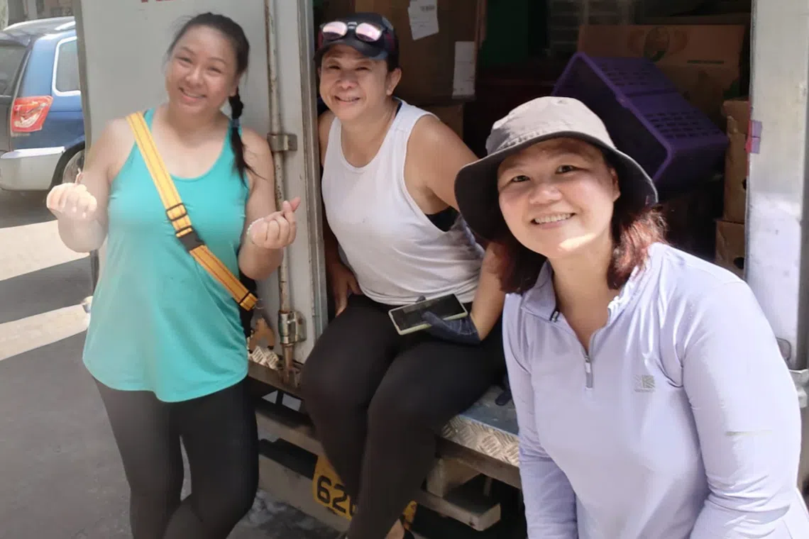 The Red Collective co-founder Winnie Cheong (centre) works with volunteers to distribute food in the Eunos neighbourhood.