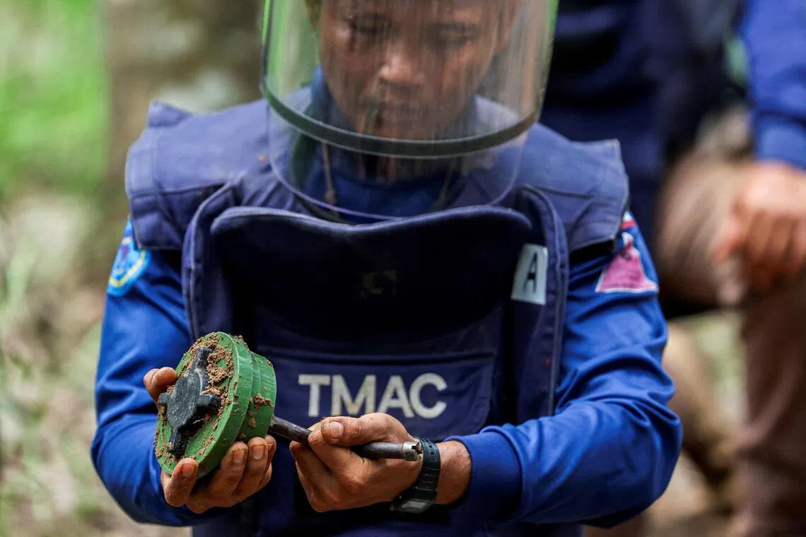 A member of the Thailand Mine Action Centre demonstrates a PMN-2 mine detonation.