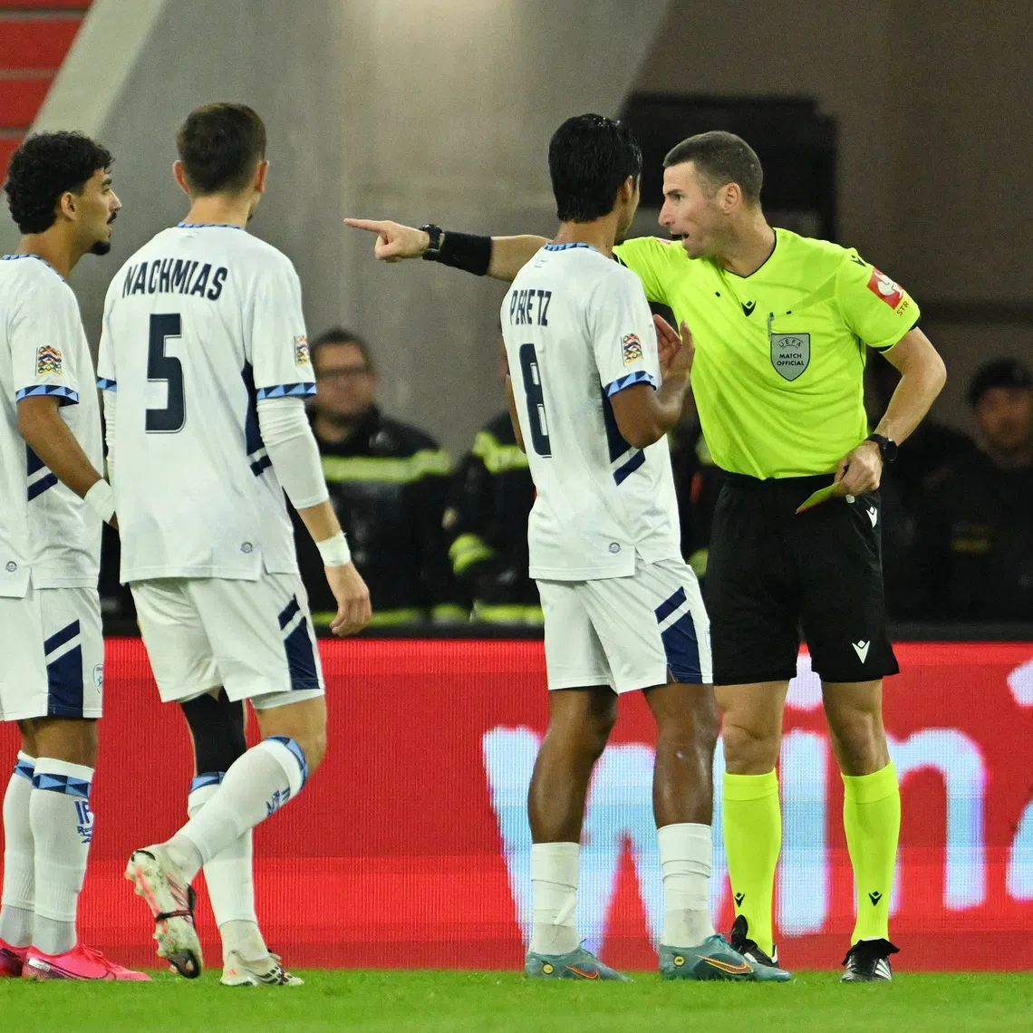 Soccer Football - Nations League - Group G - Austria v Israel - Raiffeisen Arena, Linz, Austria - September 24, 2026 Israel's Roy Revivo, Idan Nachmias and Dor Peretz remonstrate with referee Georgi Kabakov after Israel's Sayed Abu Farchi is shown a red card REUTERS/Elisabeth Mandl