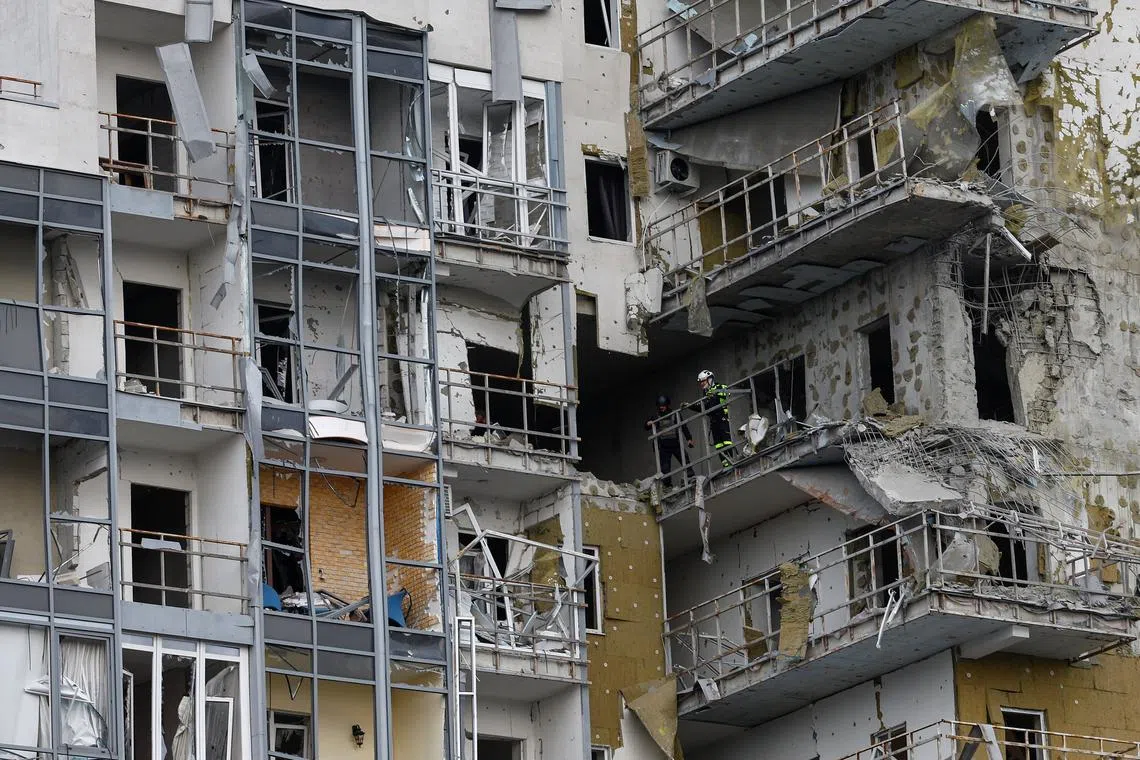 Emergency workers inspect an apartment building damaged by a Russian air strike, amid Russia's attack on Ukraine, in Kharkiv, Ukraine May 14, 2024. REUTERS/Valentyn Ogirenko