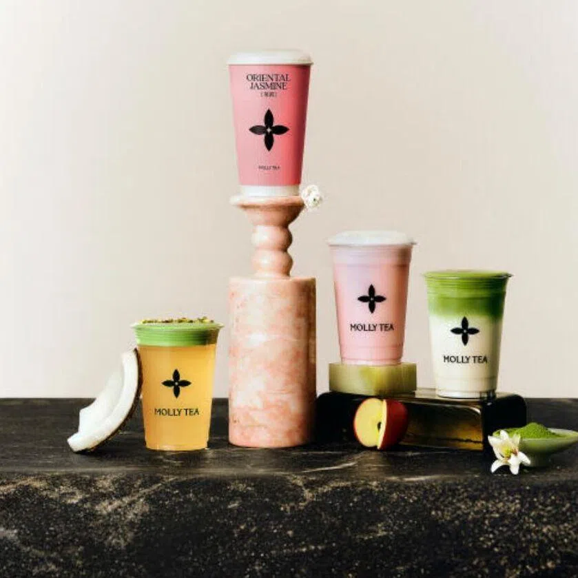 The dispute revolves around the similarity between Molly Tea’s brand emblem (left) and and Louis Vuitton’s iconic monogram motifs (right).