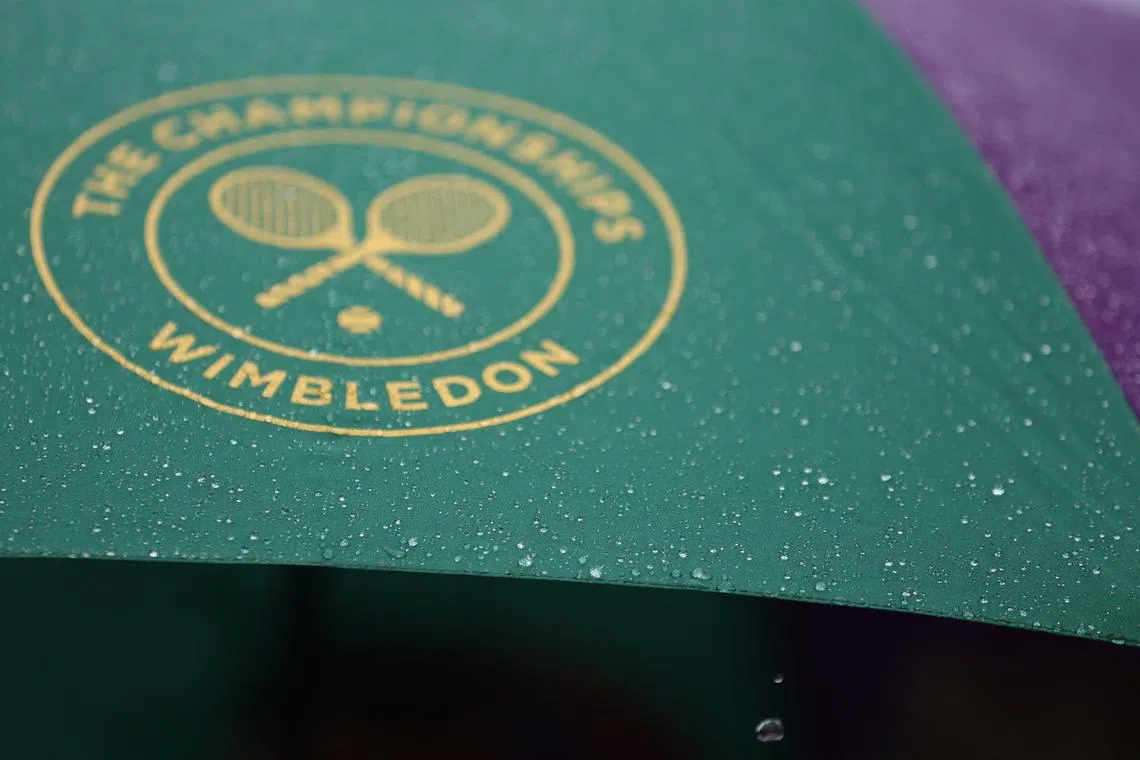 FILE PHOTO: Tennis - Wimbledon - All England Lawn Tennis and Croquet Club, London, Britain - July 4, 2023 General view of an umbrella with the Wimbledon logo during a rain delay REUTERS/Hannah Mckay/File Photo
