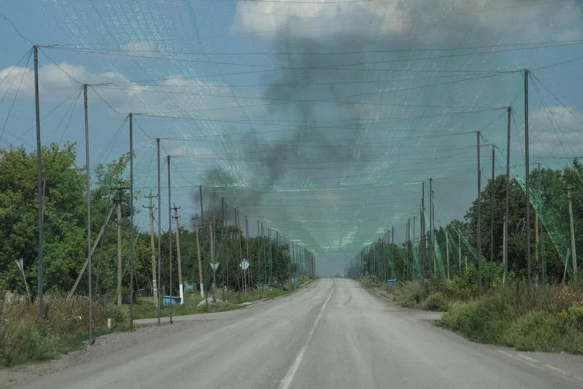 Anti-drone nets installed over a road near the front-line town of Dobropillia, in Ukraine's Donetsk region, on Aug 10.