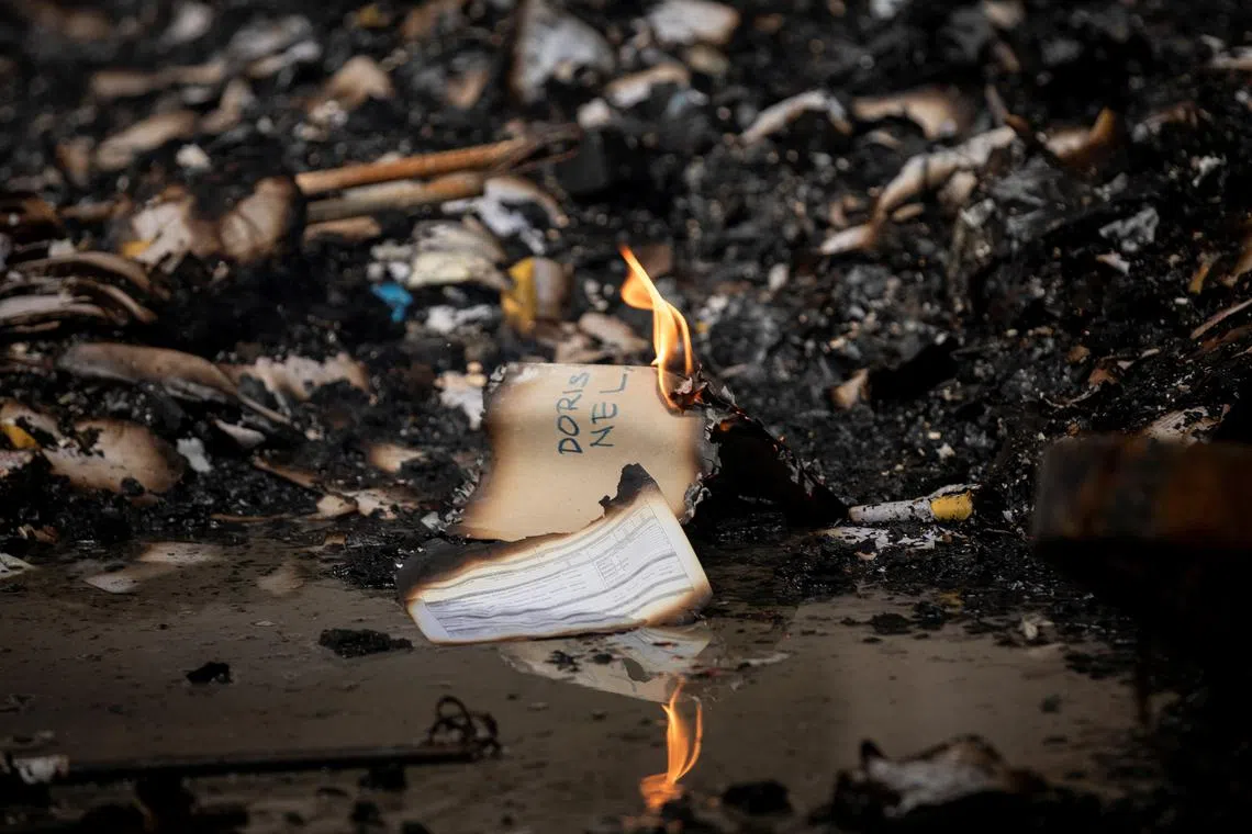 Smouldering paper seen inside the burning Manila Central Post Office building after a massive fire, in Manila, Philippines, May 22, 2023. 