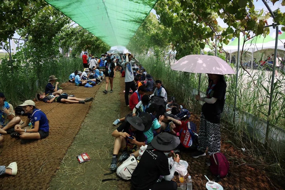 Participants take shelter from the strong sunlight at the camping site for the 25th World Scout Jamboree in Busan, on Aug 4.