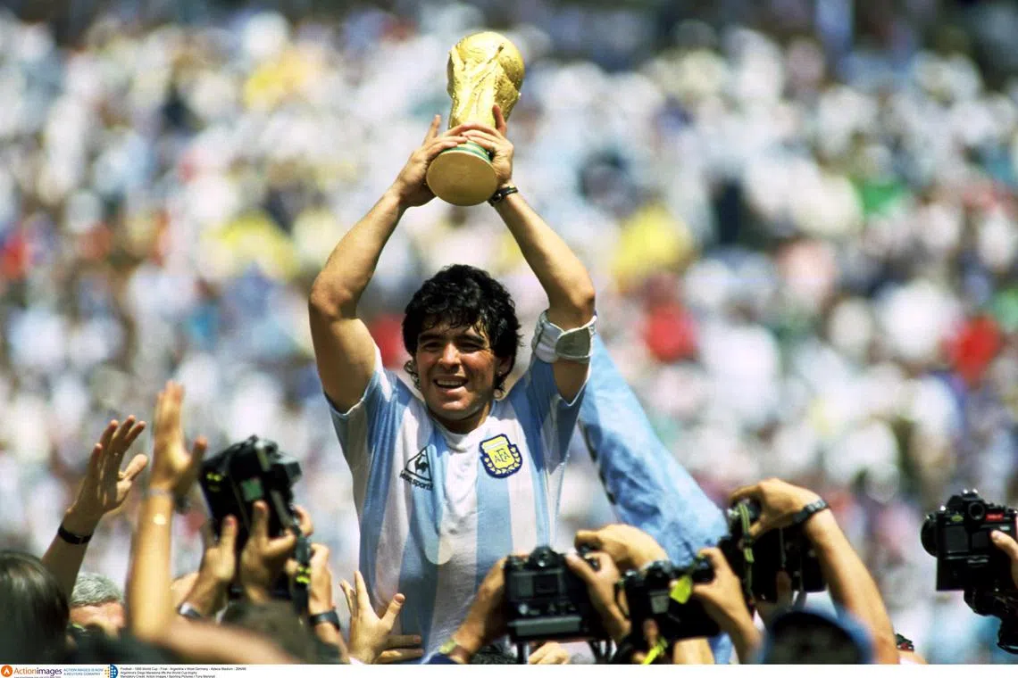 Diego Maradona, died in 2020 aged 60, raises the Word Cup trophy in 1986.